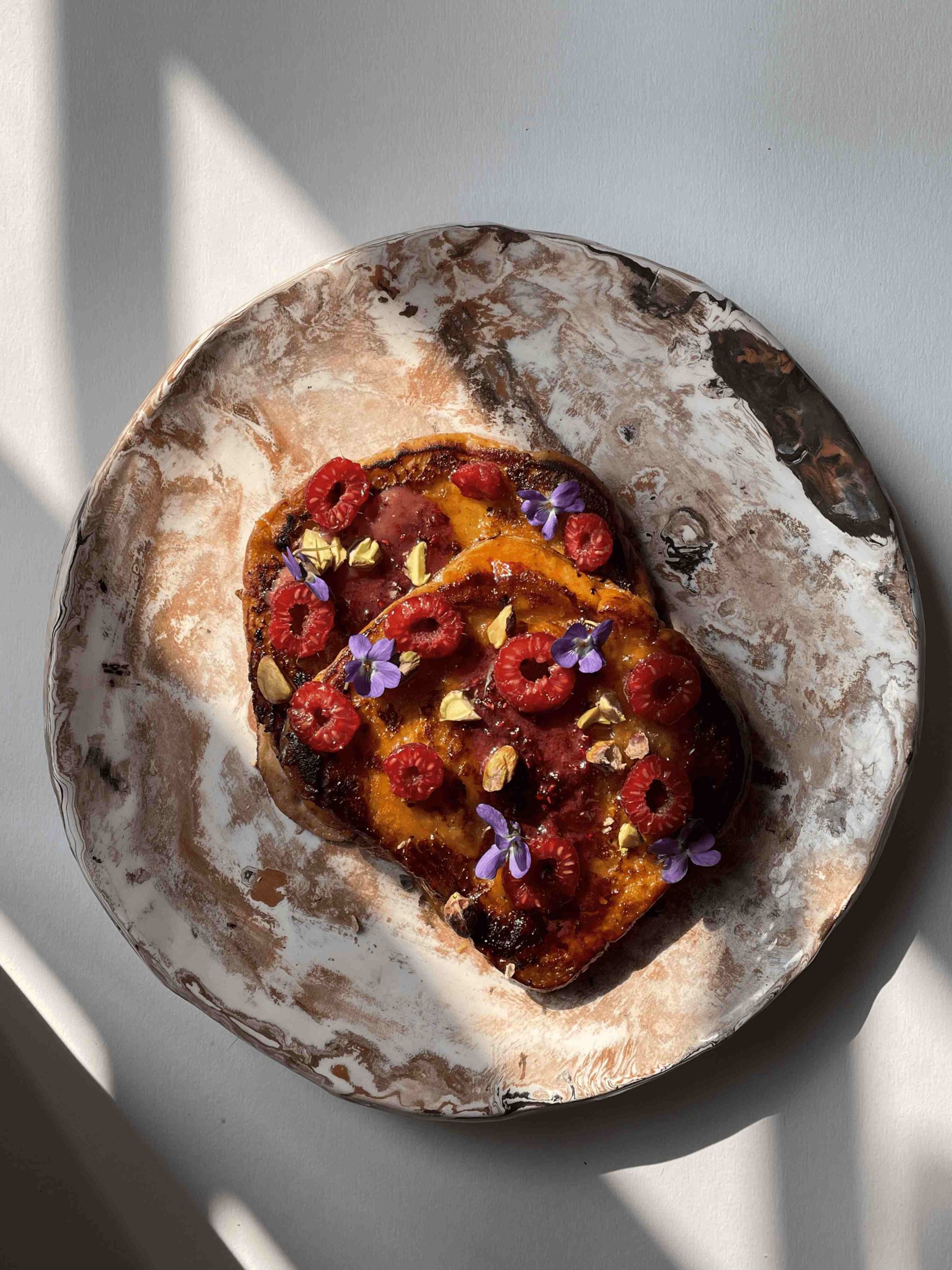 Brioche French toast, Bordier Raspberry Butter, fresh raspberries and roasted pistachios